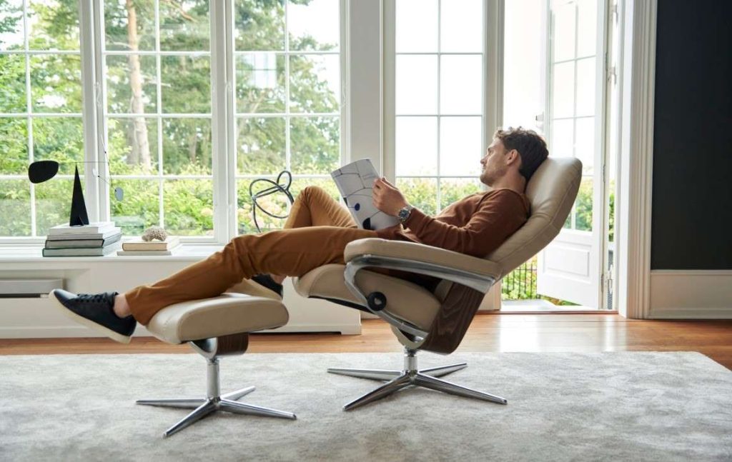 Person leaning back and reading in Stressless® Consul recliner