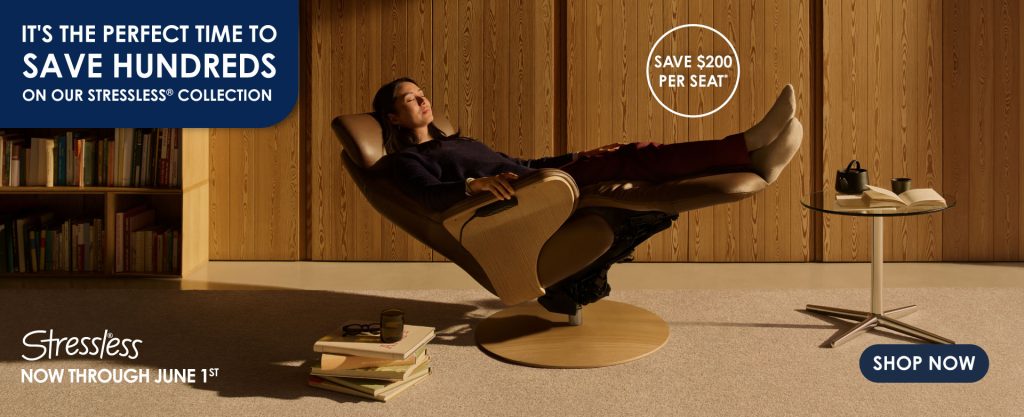 Person relaxing in the Stressless Adam recliner. Golden hour. Table near the recliner. Promotes saving hundreds on stressless products until June 1st.