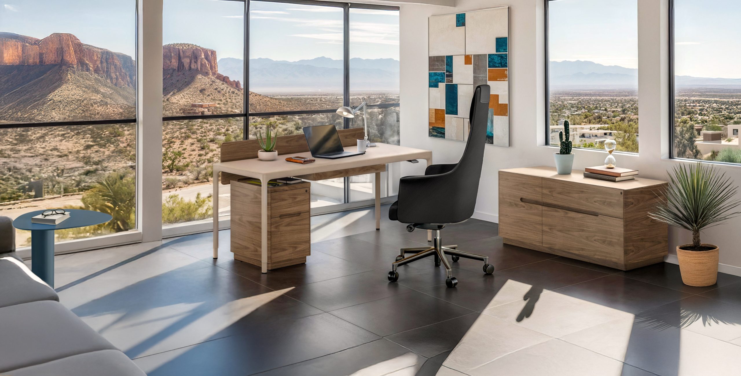 A modern office featuring the BDI Luma desk, with a view of a desert through the windows.